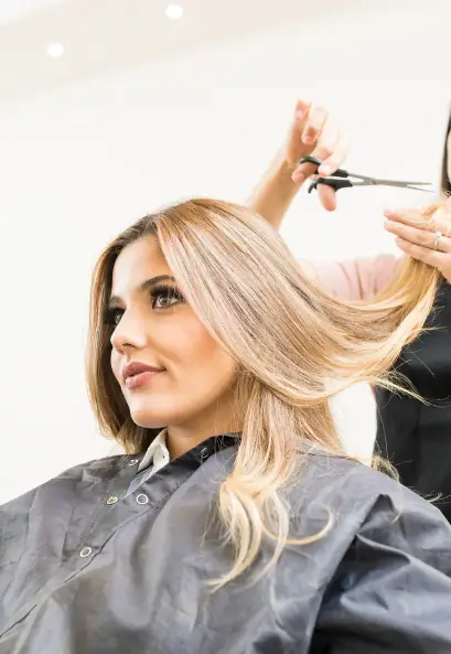 Woman with long hair receiving a hair cut and new style at SurePose