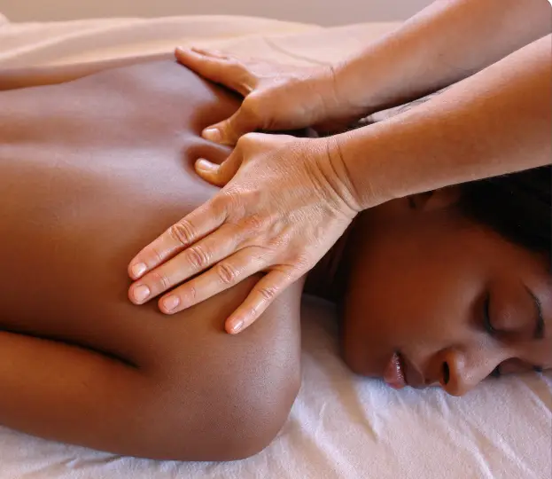 Woman laying on massage table getting a Swedish massage