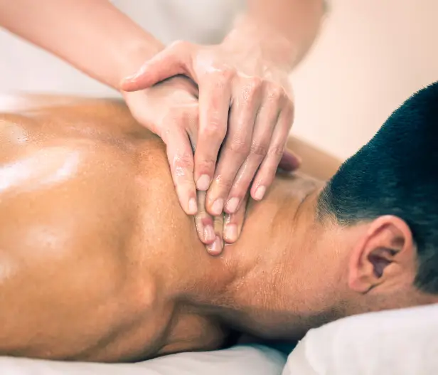 Man enjoying a sports massage to relax tight muscles in Newton Kansas